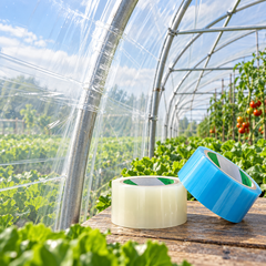 Blue and transparent greenhouse repair tape displayed beside repaired agricultural greenhouse film.