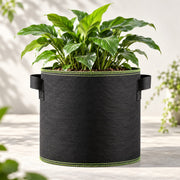 Illustrative two-handle green-edge grow bag in a light patio setting. Plants, soil and props excluded.