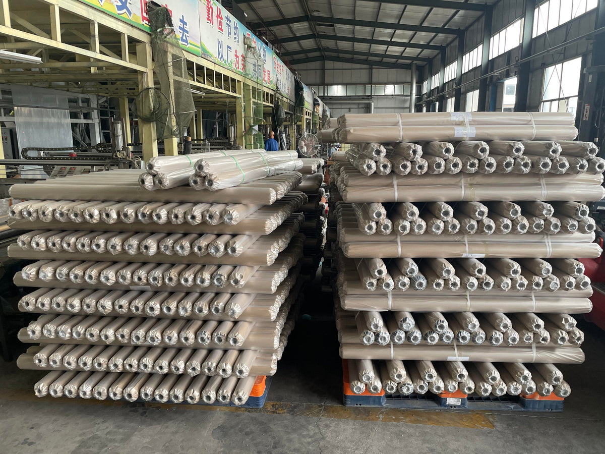 Agricultural white fabric rolls arranged in a production warehouse